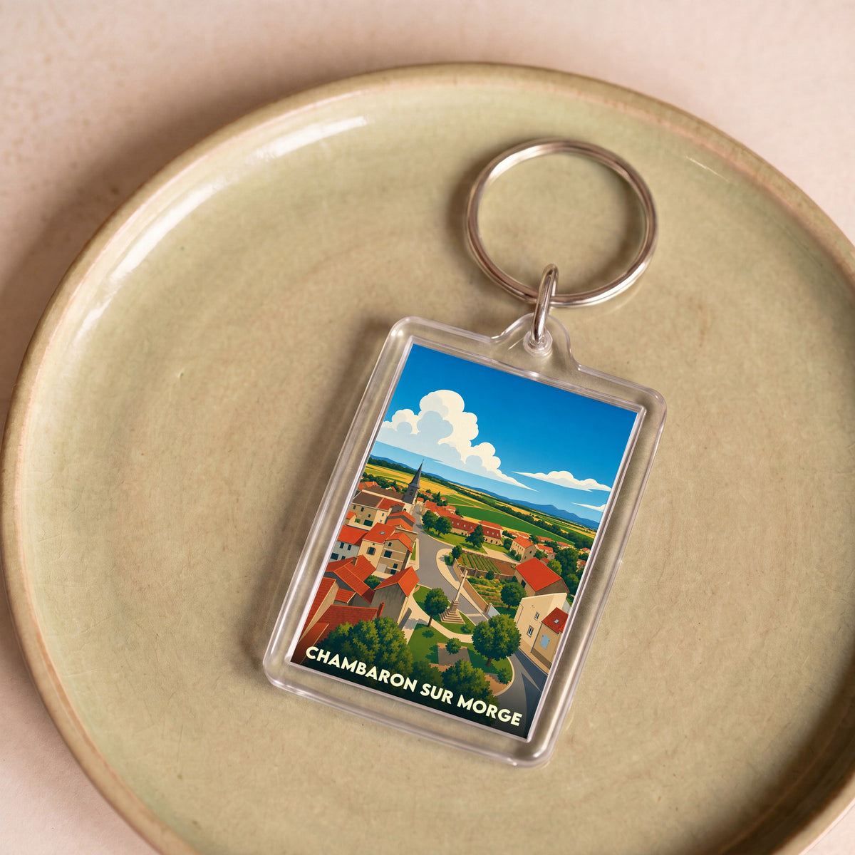 Porte-clés souvenir de la ville de Chambaron sur Morge avec une illustration stylisée.