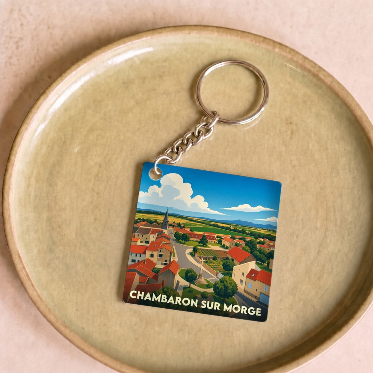 Porte-clés souvenir de la ville de Chambaron sur Morge avec une illustration stylisée.