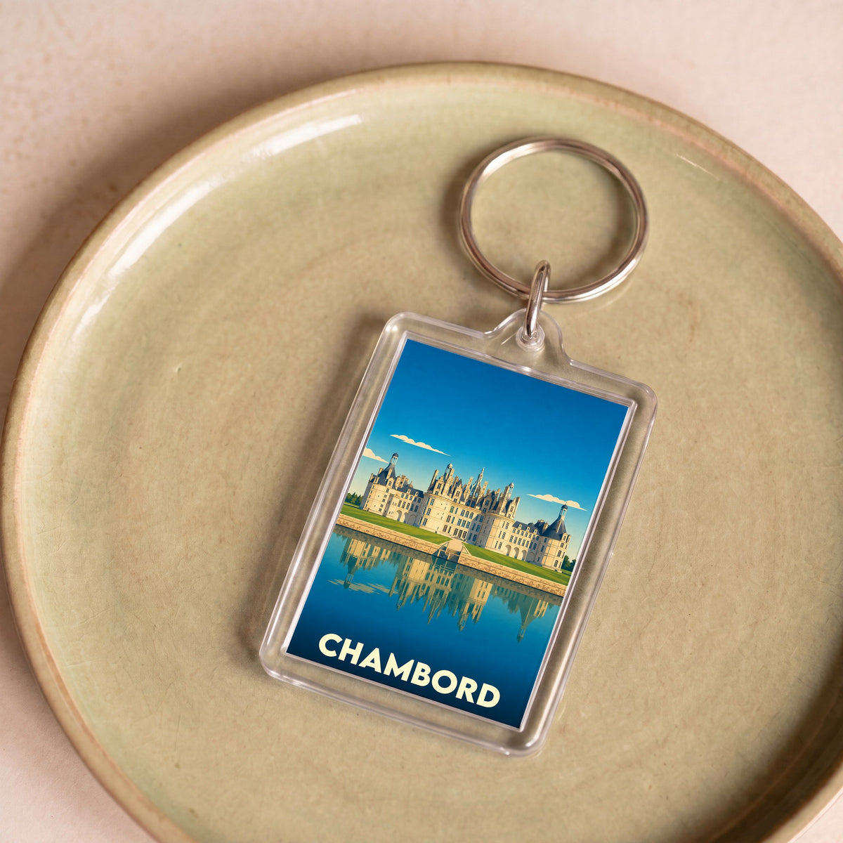 Porte-clés souvenir de la ville de Chambord avec une illustration stylisée du château.