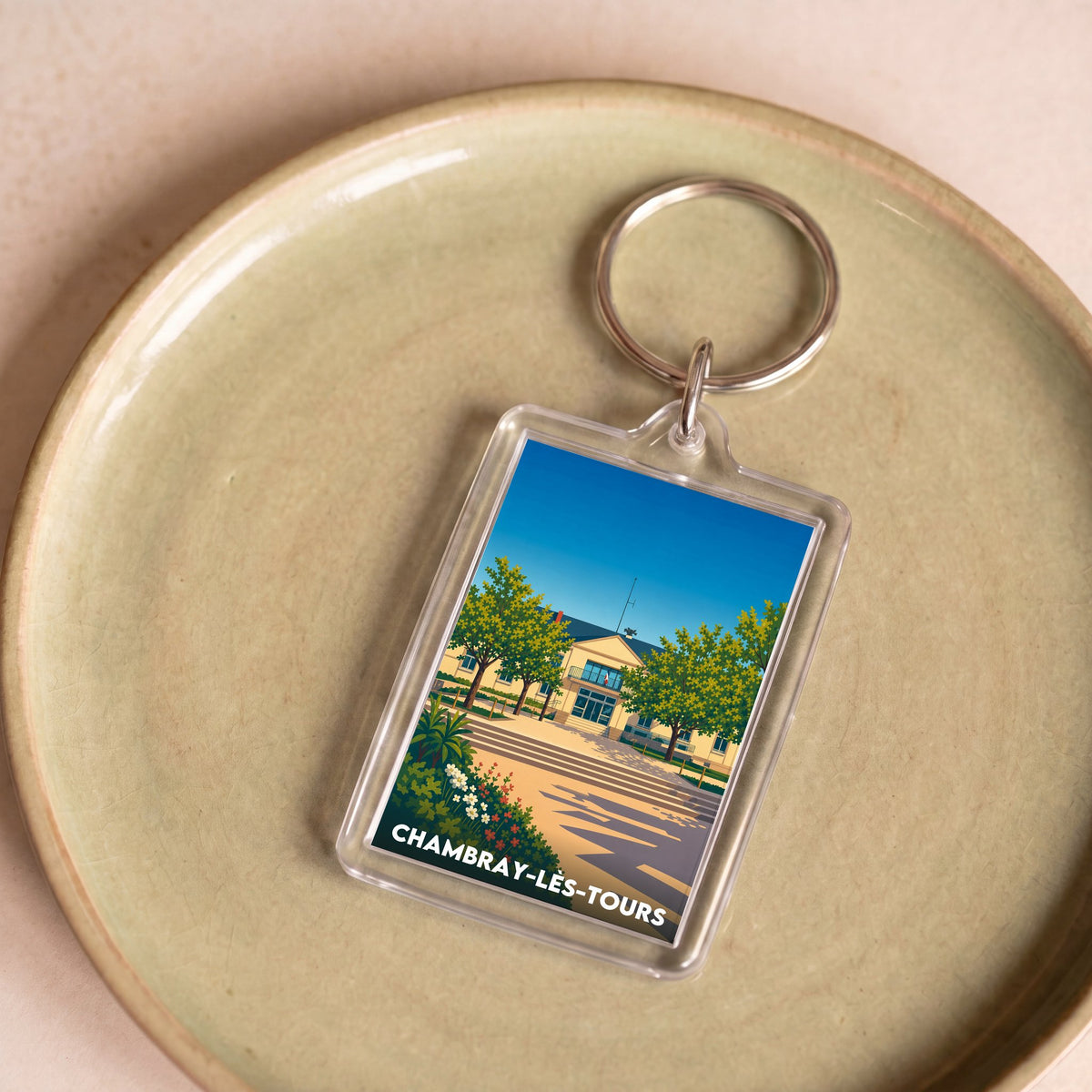Porte-clés souvenir de la ville de Chambray-lès-Tours avec une illustration stylisée et colorée.
