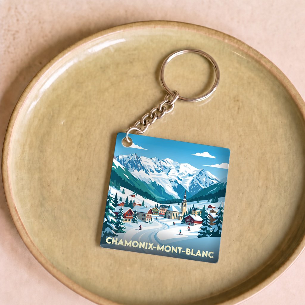 Porte-clés souvenir de la ville de Chamonix-Mont-Blanc avec une illustration stylisée de montagne.