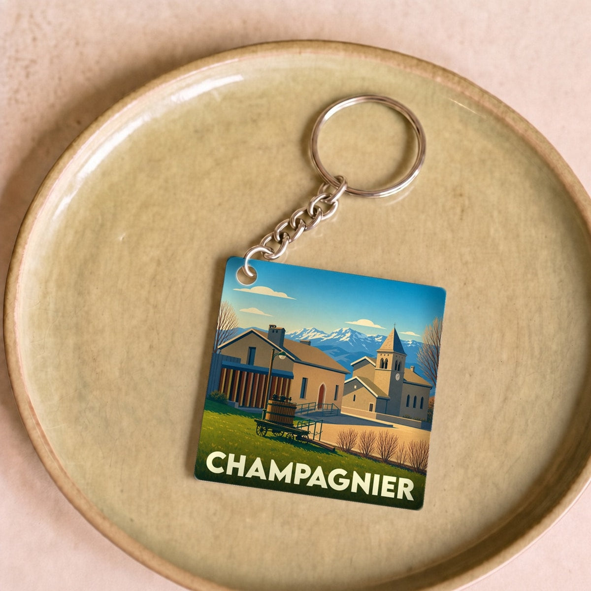 Porte-clés souvenir de la ville de Champagnier avec une illustration stylisée.