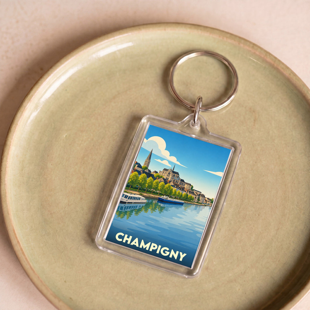 Porte-clés souvenir de la ville de Champigny avec une illustration stylisée des bords de Marne.