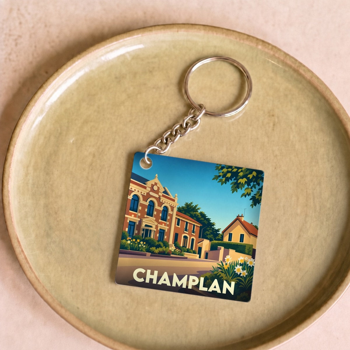 Porte-clés souvenir de la ville de Champlan avec une illustration stylisée.