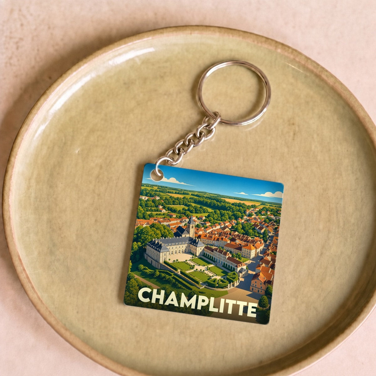 Porte-clés souvenir de la ville de Champlitte avec une illustration stylisée vue du ciel.
