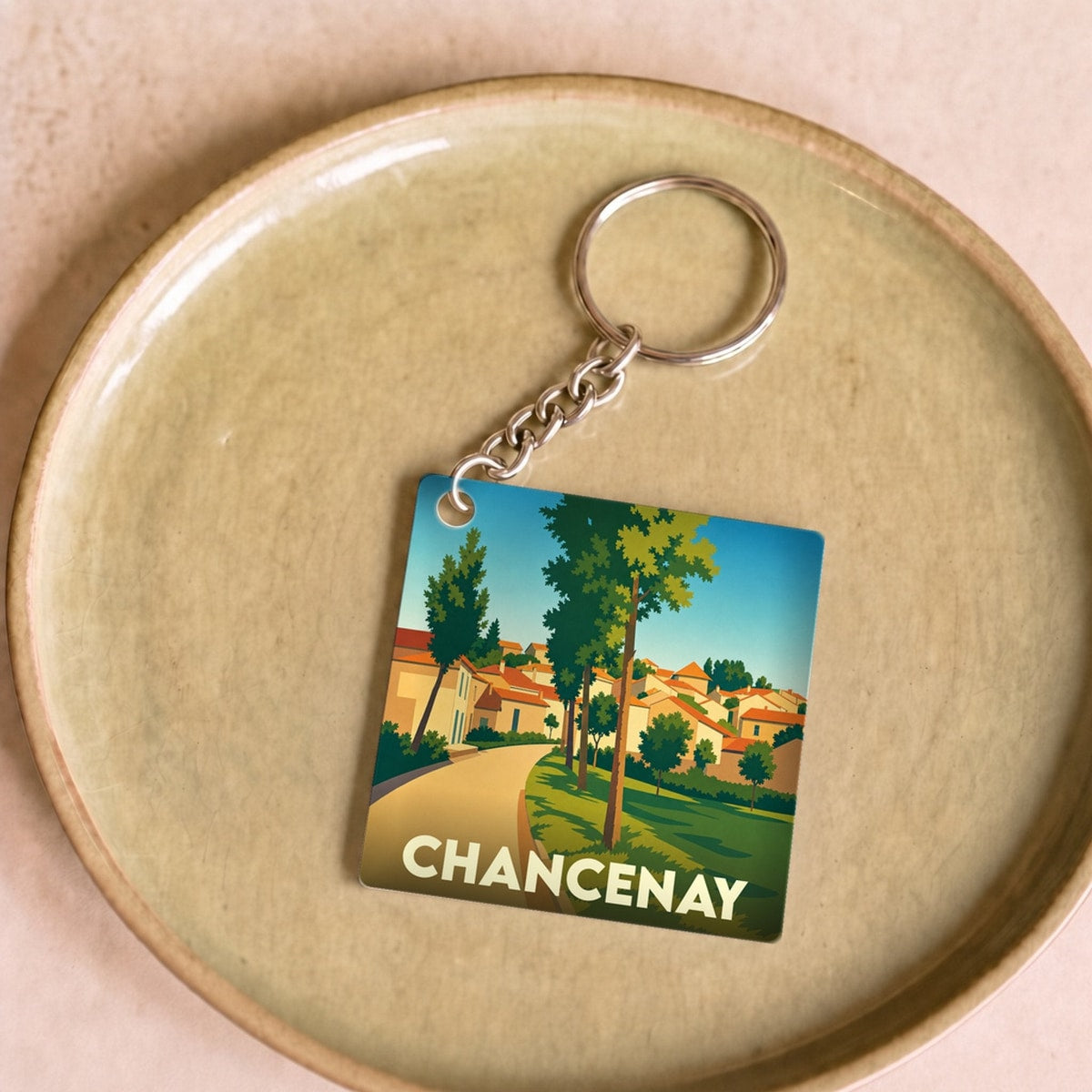 Porte-clés souvenir de la ville de Chancenay avec une illustration stylisée et colorée.