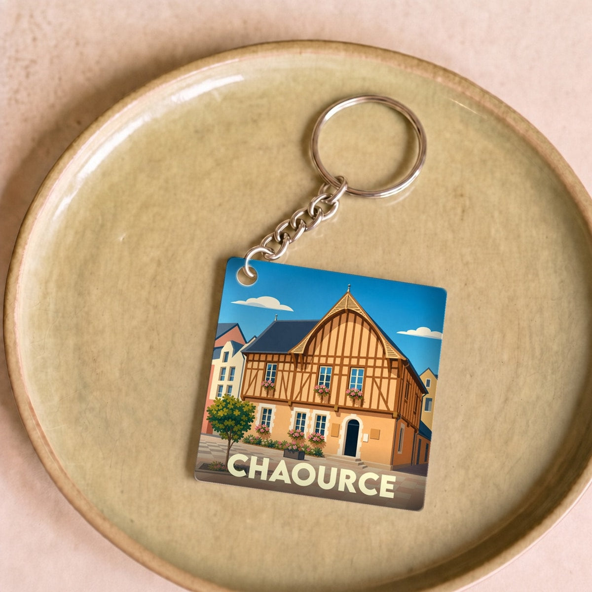 Porte-clés souvenir de la ville de Chaource avec une illustration stylisée.