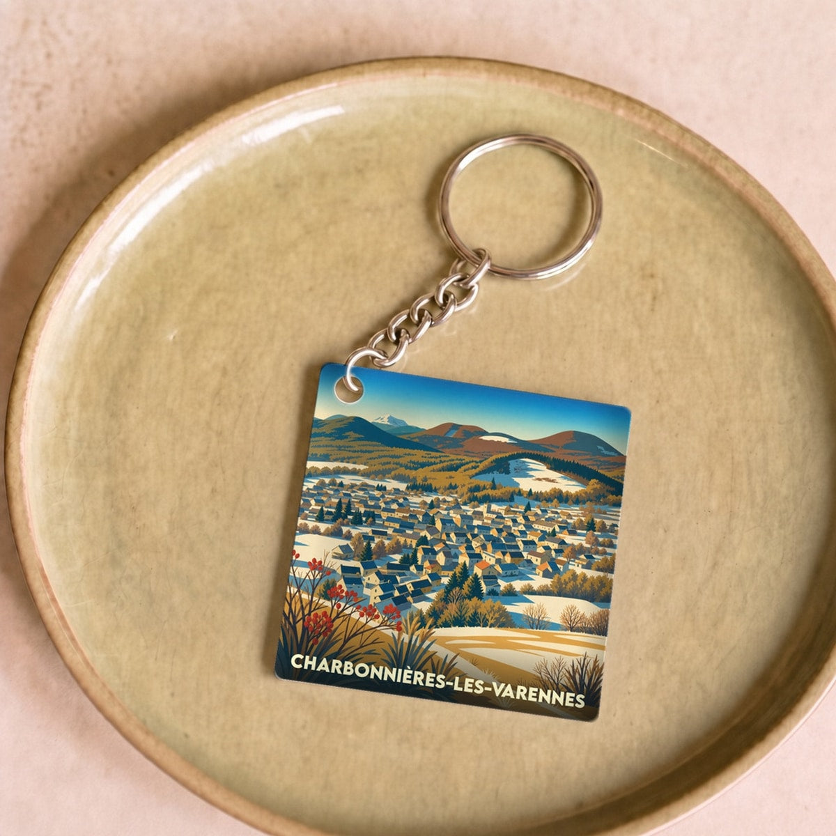 Porte-clés souvenir de la ville de Charbonnières-les-Varennes avec une illustration stylisée.
