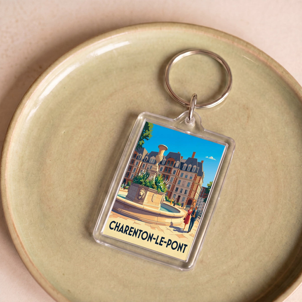 Porte-clés souvenir de la ville de Charenton-le-Pont avec une illustration stylisée d'une place historique.