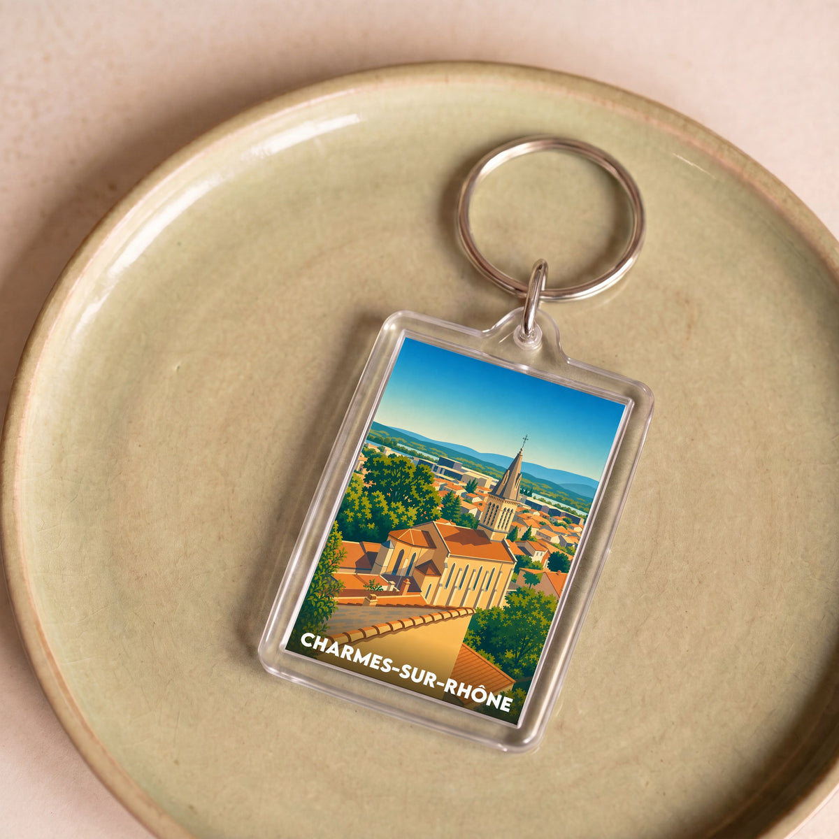 Porte-clés souvenir de la ville de Charmes-sur-Rhône avec une illustration stylisée.