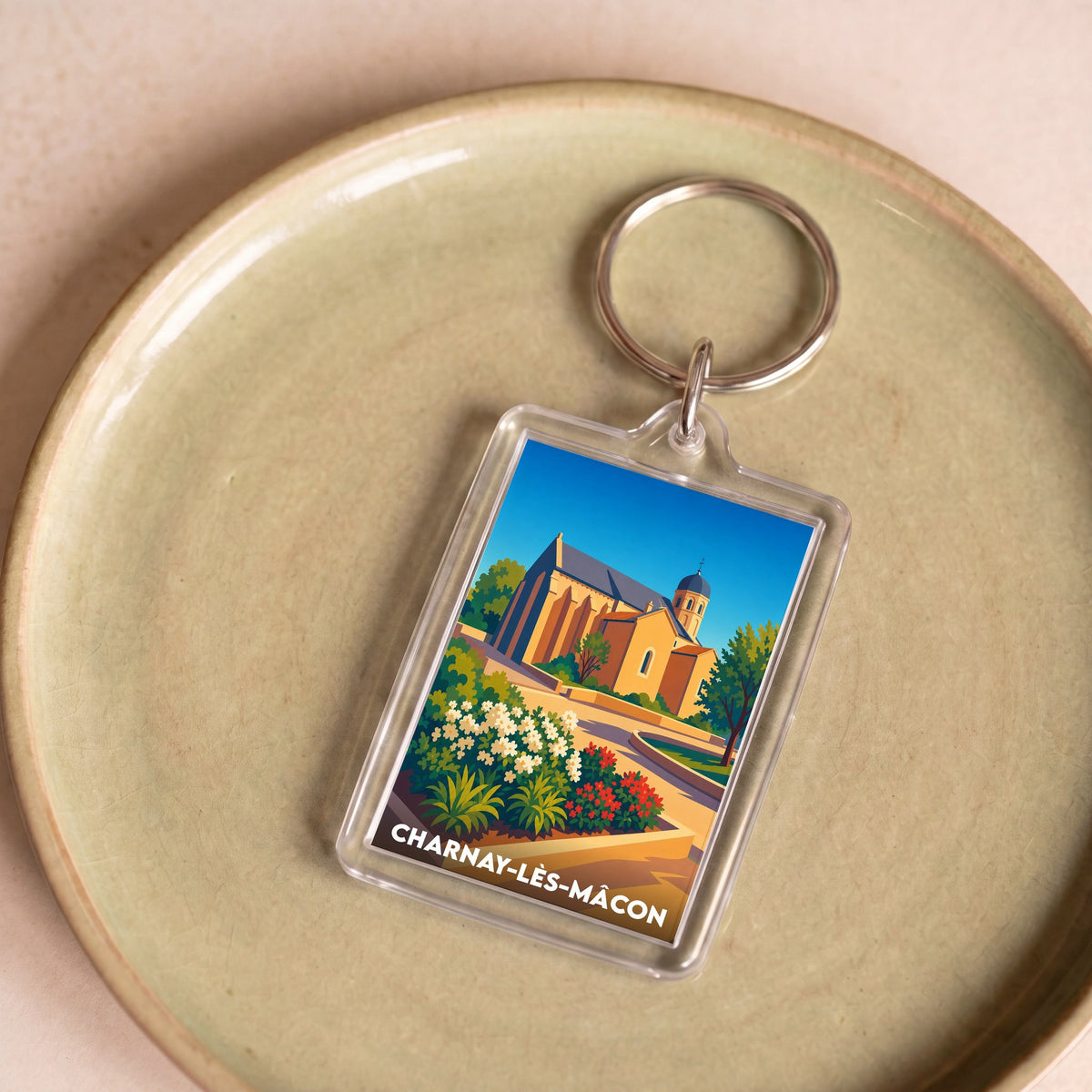 Porte-clés souvenir de Charnay-lès-Mâcon avec une illustration stylisée de son patrimoine.