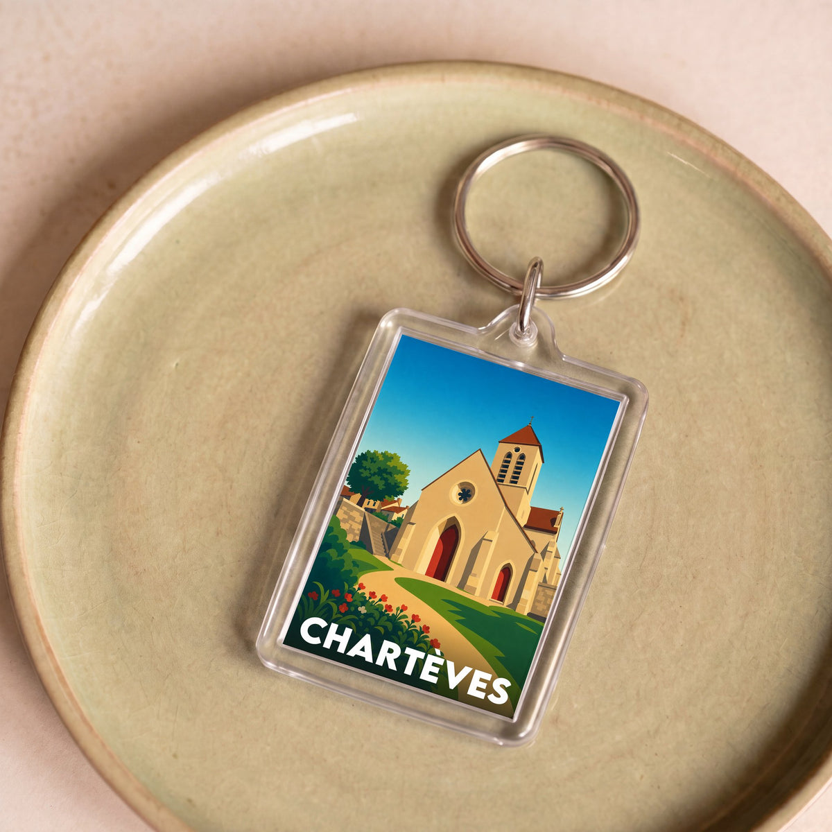 Porte-clés souvenir de la ville de Chartèves avec une illustration stylisée.