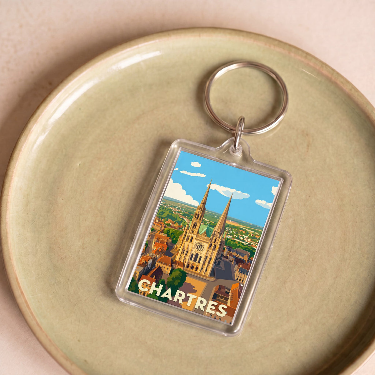 Porte-clés souvenir de la ville de Chartres avec une illustration stylisée de sa cathédrale.
