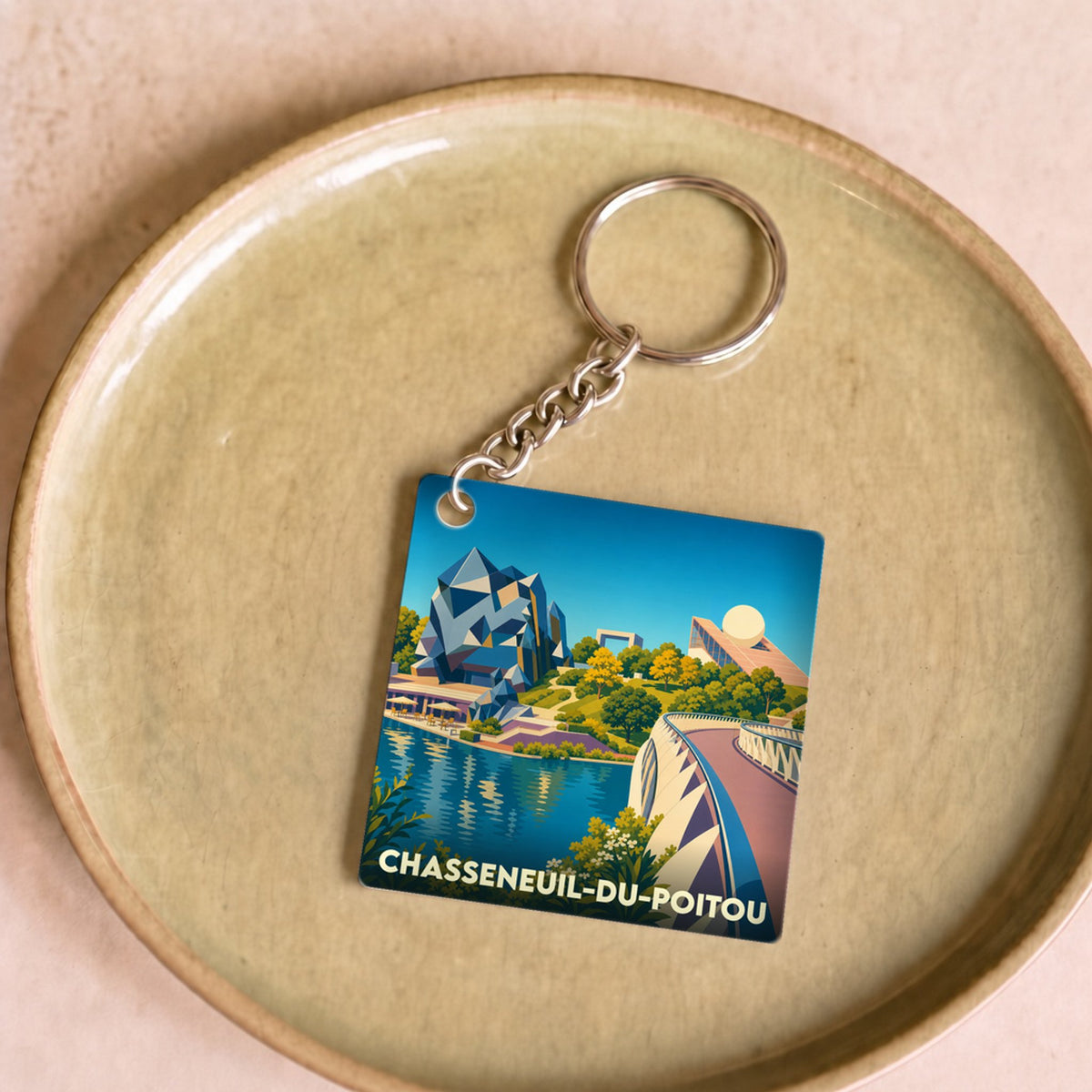 Porte-clés souvenir de la ville de Chasseneuil-du-Poitou avec une illustration stylisée du Futuroscope.