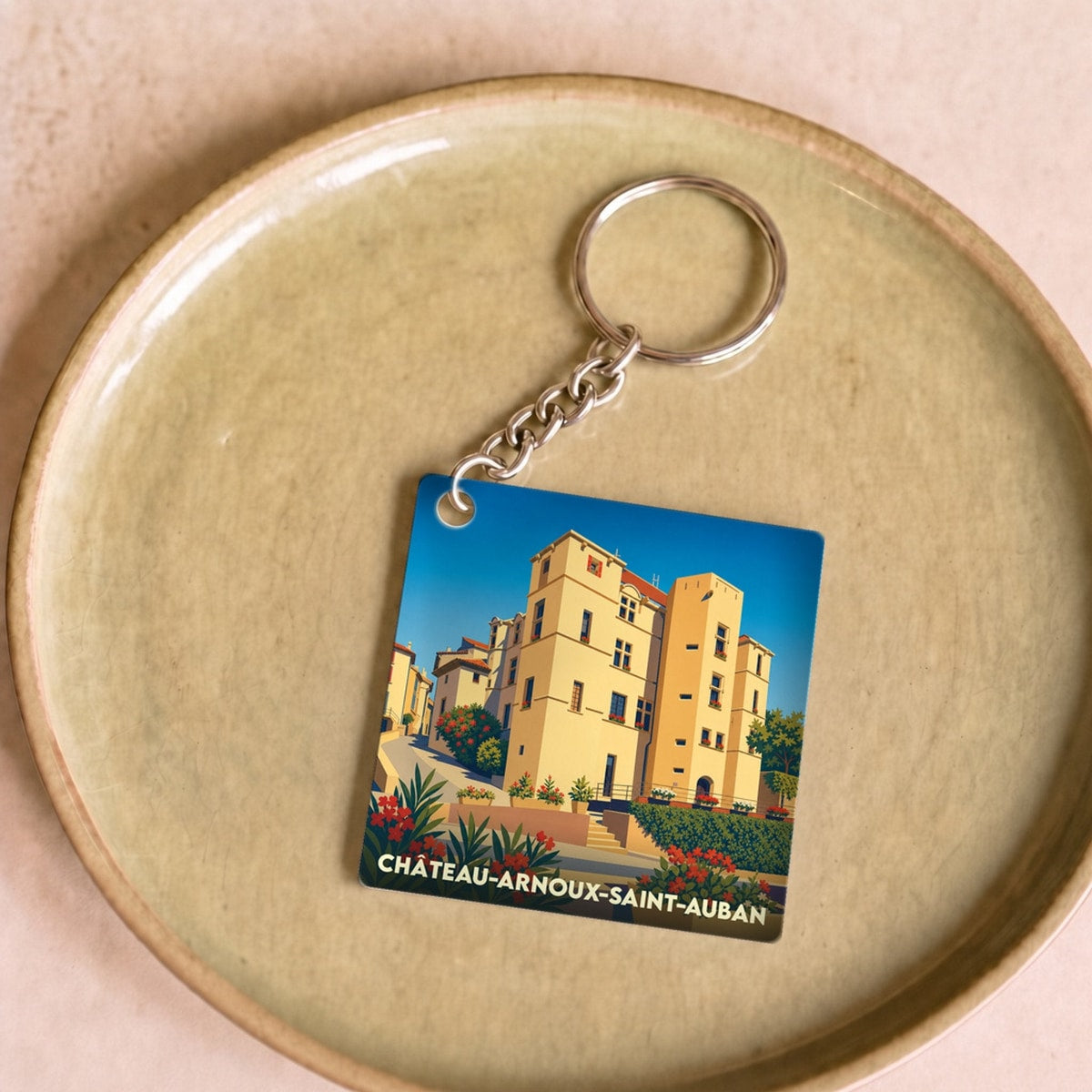 Porte-clés souvenir de la ville de Château-Arnoux-Saint-Auban avec une illustration stylisée.
