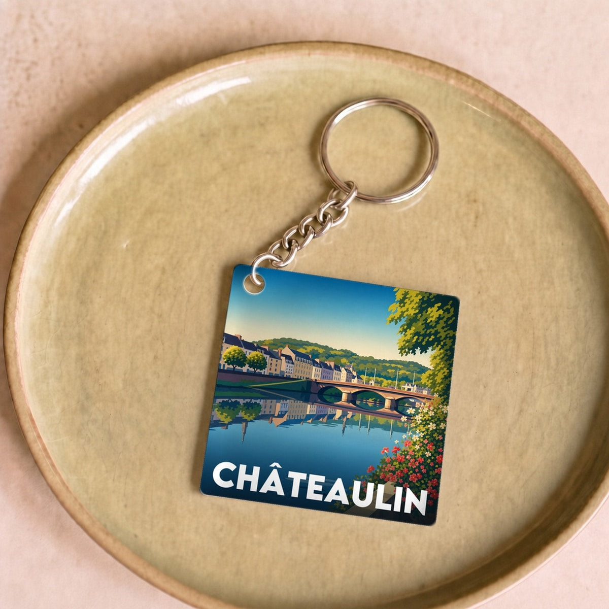Porte-clés souvenir de la ville de Châteaulin avec une illustration stylisée.