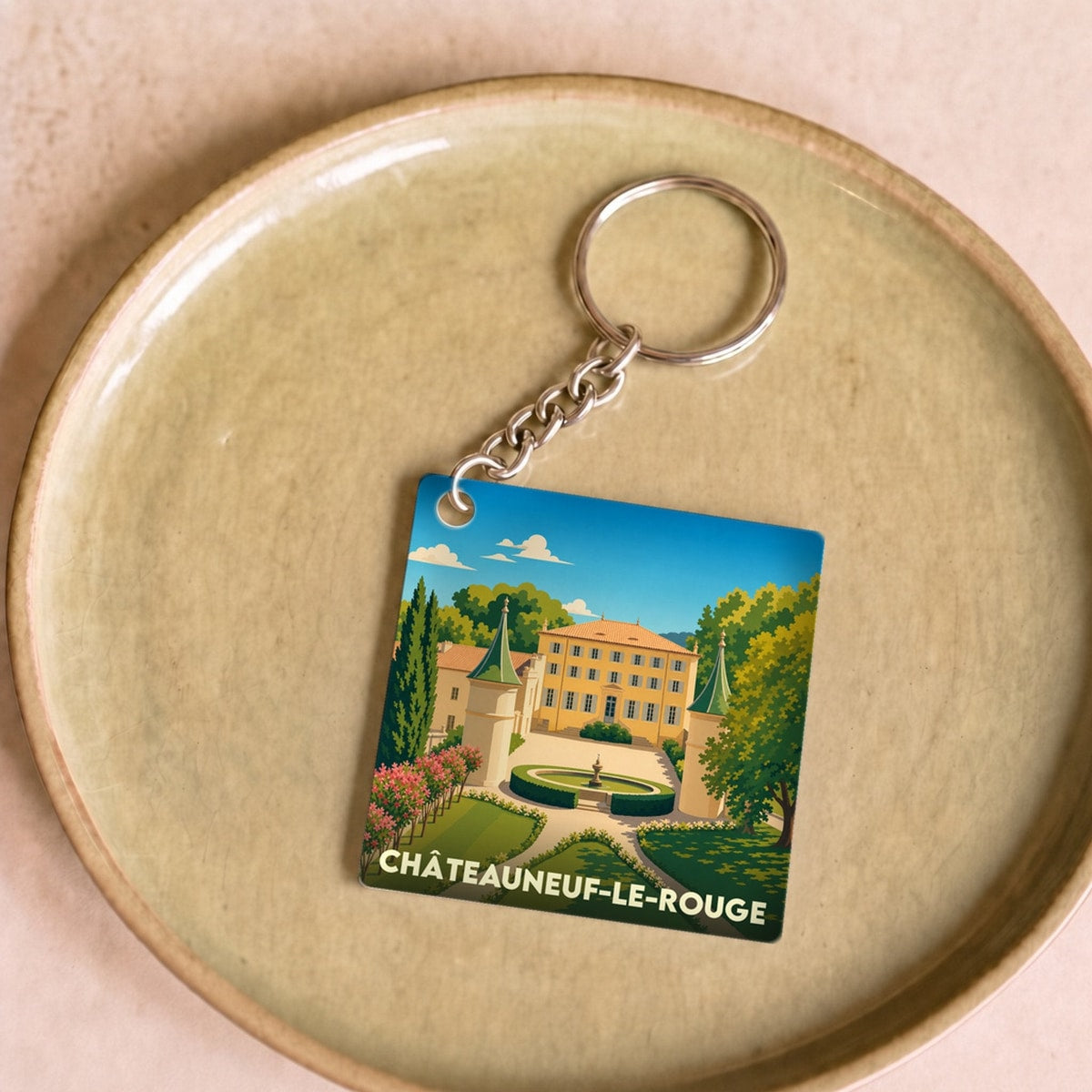 Porte-clés souvenir de la ville de Châteauneuf-le-Rouge avec une illustration stylisée de son château.