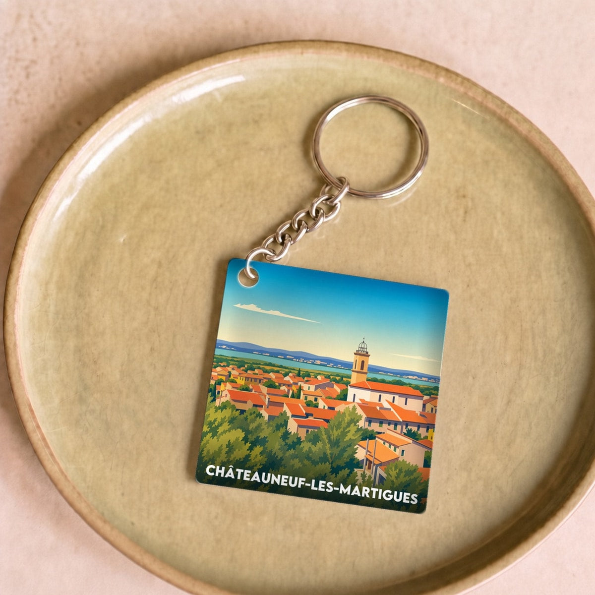 Porte-clés souvenir de la ville de Châteauneuf-les-Martigues avec une illustration stylisée.