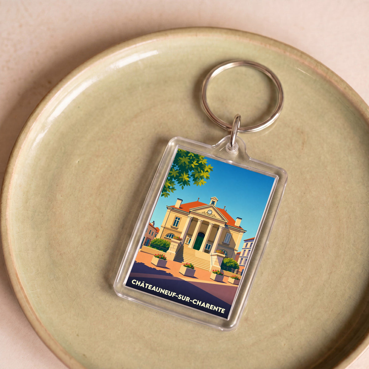 Porte-clés souvenir de la ville de Châteauneuf-sur-Charente avec une illustration stylisée.