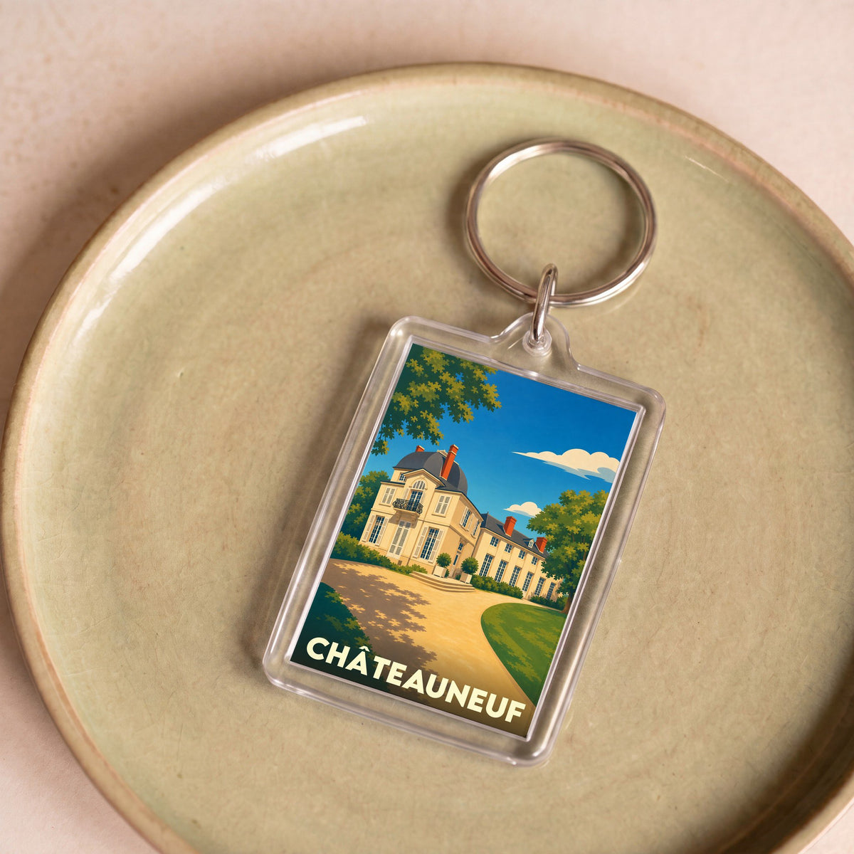 Porte-clés souvenir de la ville de Châteauneuf avec une illustration stylisée de son château.