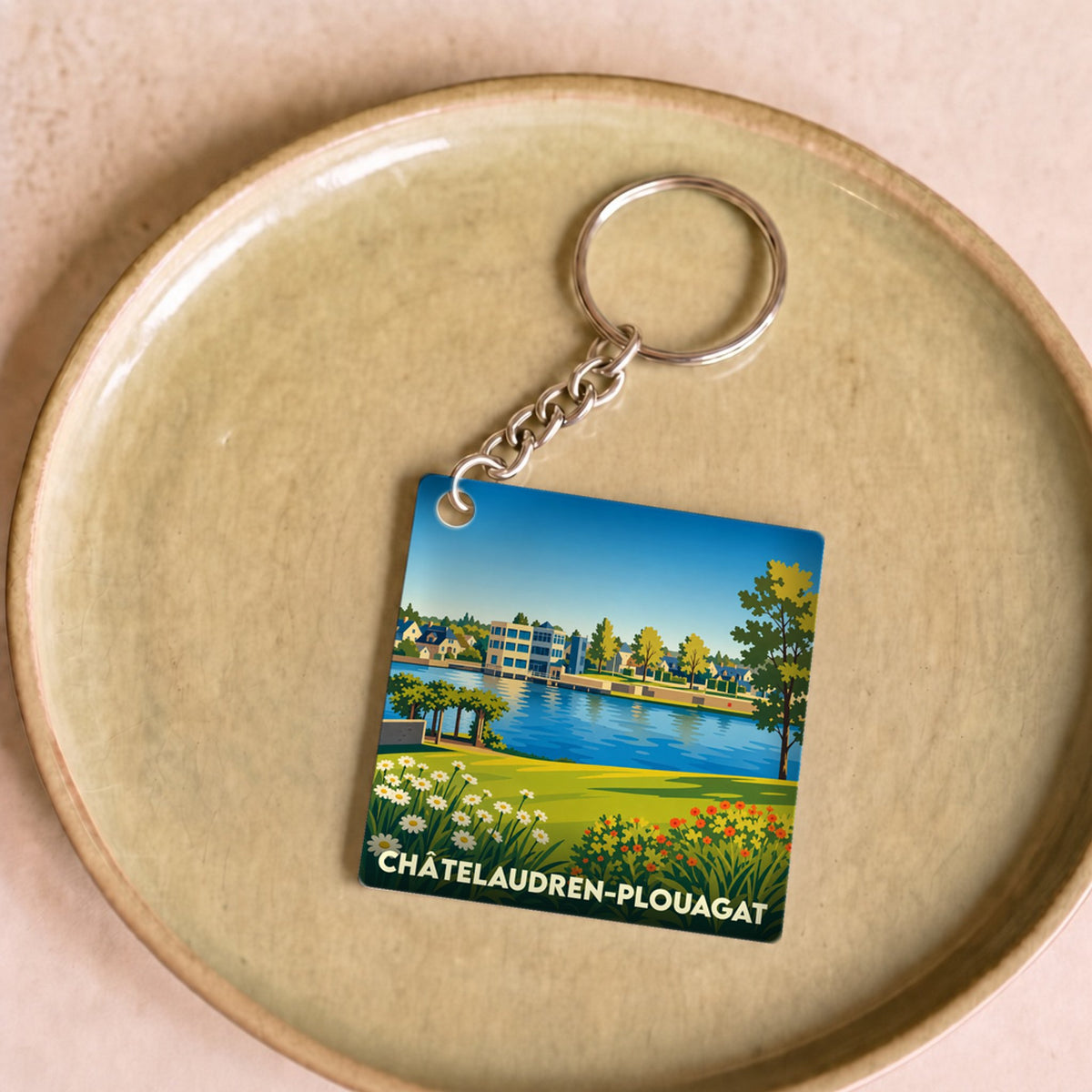 Porte-clés souvenir de la ville de Châtelaudren-Plouagat avec une illustration stylisée.