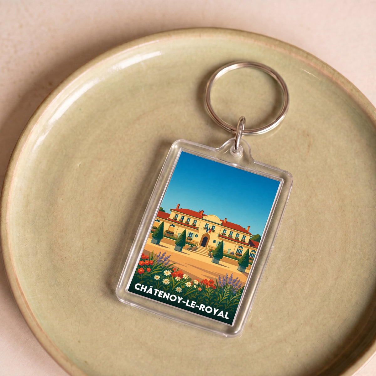 Porte-clés souvenir de la ville de Châtenoy-le-Royal avec une illustration stylisée.