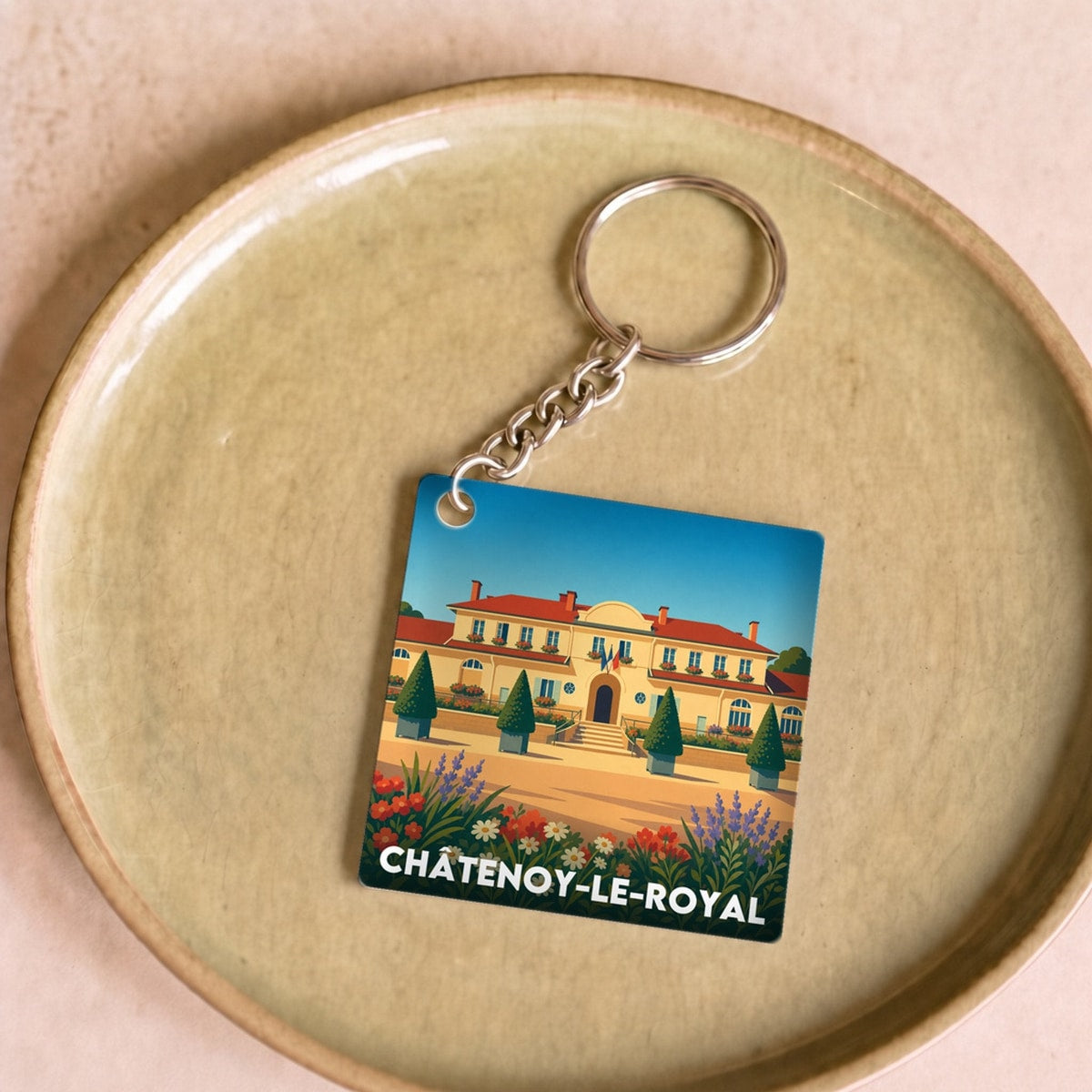 Porte-clés souvenir de la ville de Châtenoy-le-Royal avec une illustration stylisée.