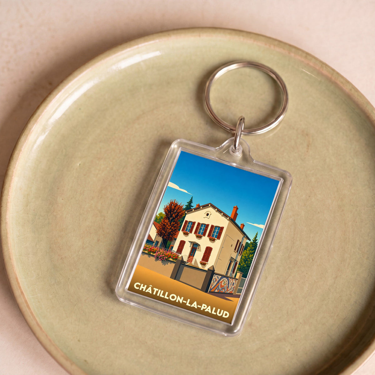 Porte-clés souvenir de la ville de Châtillon-la-Palud avec une illustration stylisée d'une maison traditionnelle.