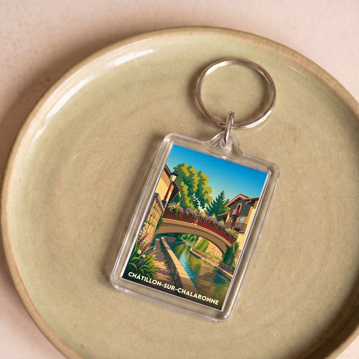 Porte-clés souvenir de la ville de Châtillon-sur-Chalaronne avec une illustration stylisée.