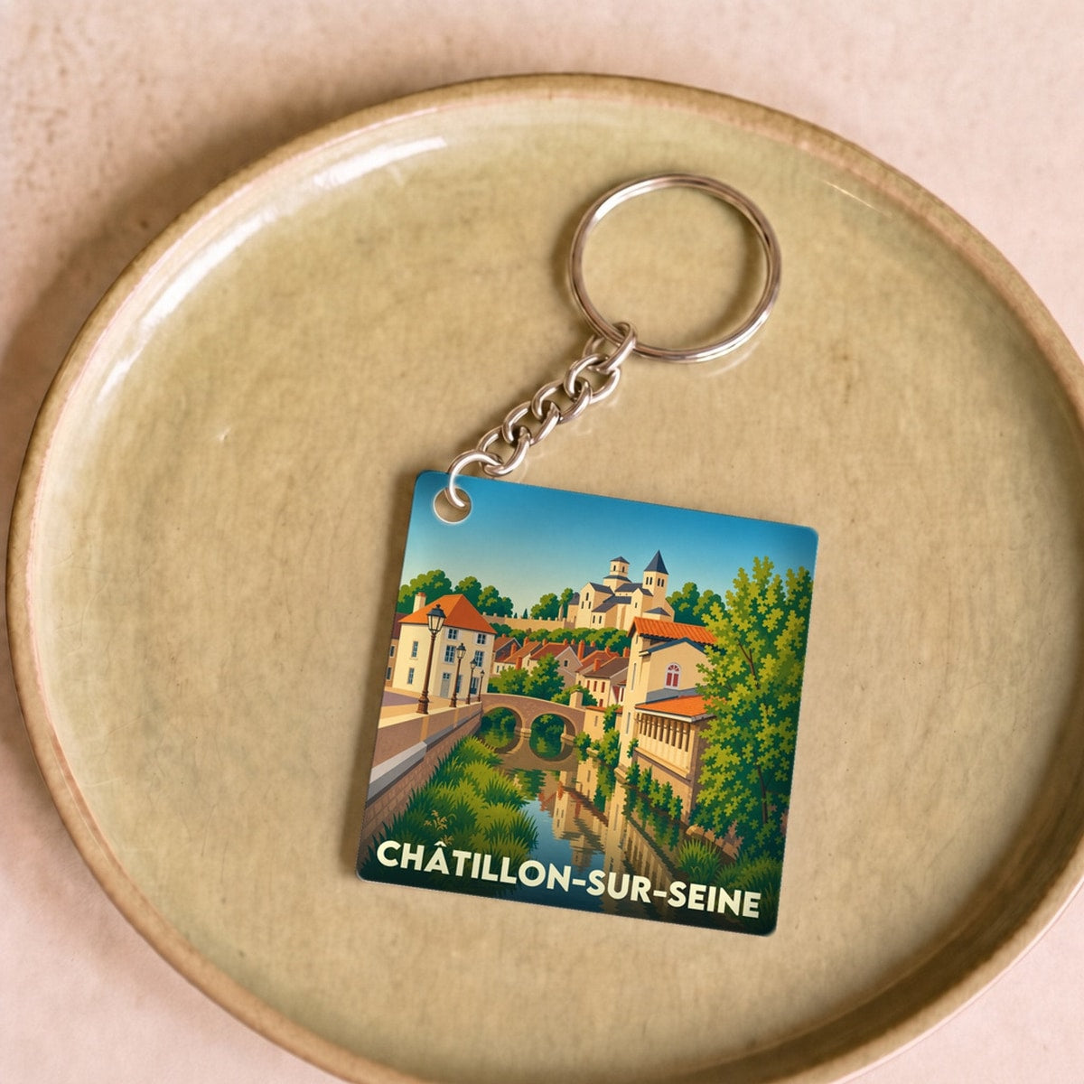 Porte-clés souvenir de la ville de Châtillon-sur-Seine avec une illustration stylisée.
