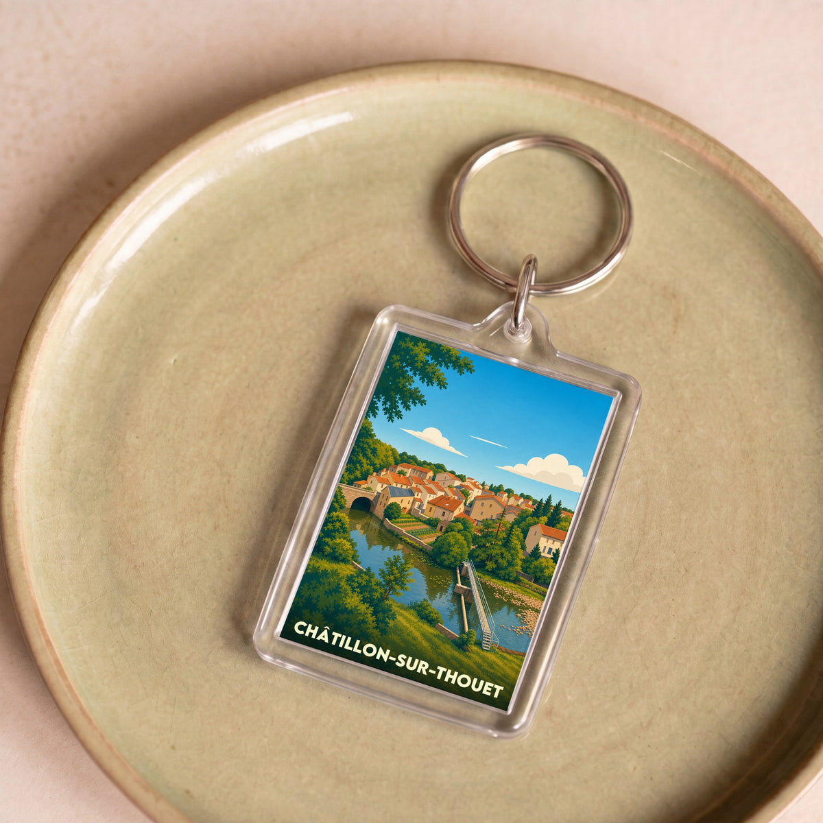 Porte-clés souvenir de la ville de Châtillon-sur-Thouet avec une illustration stylisée.