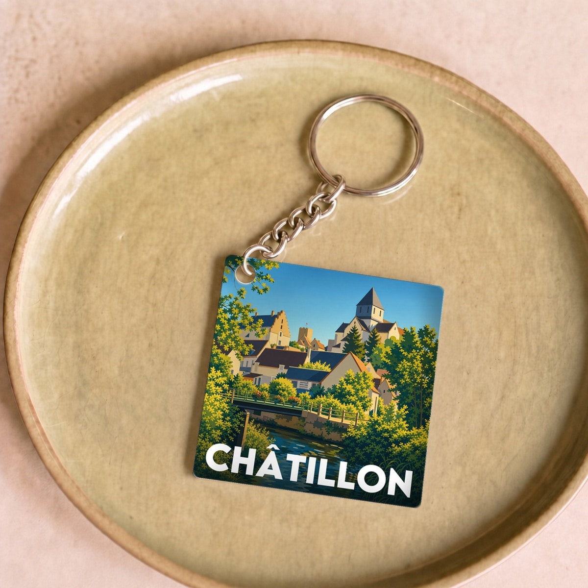 Porte-clés souvenir de la ville de Châtillon avec une illustration stylisée.