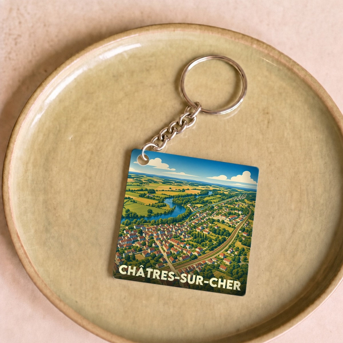 Porte-clés souvenir de la ville de Châtres-sur-Cher avec une illustration stylisée.