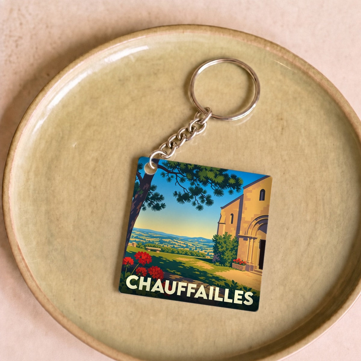 Porte-clés souvenir de la ville de Chauffailles avec une illustration stylisée.