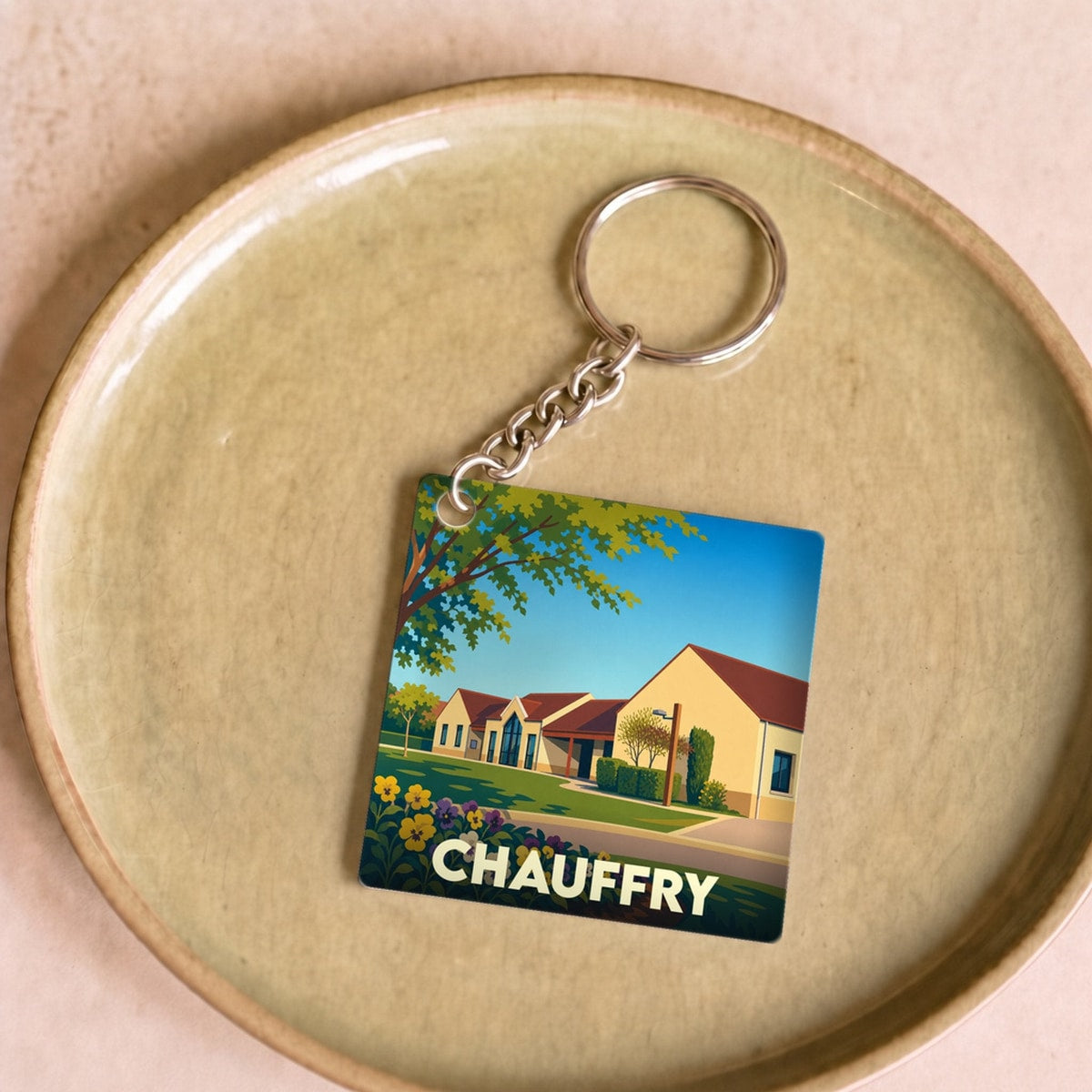 Porte-clés souvenir de la ville de Chauffry avec une illustration stylisée.
