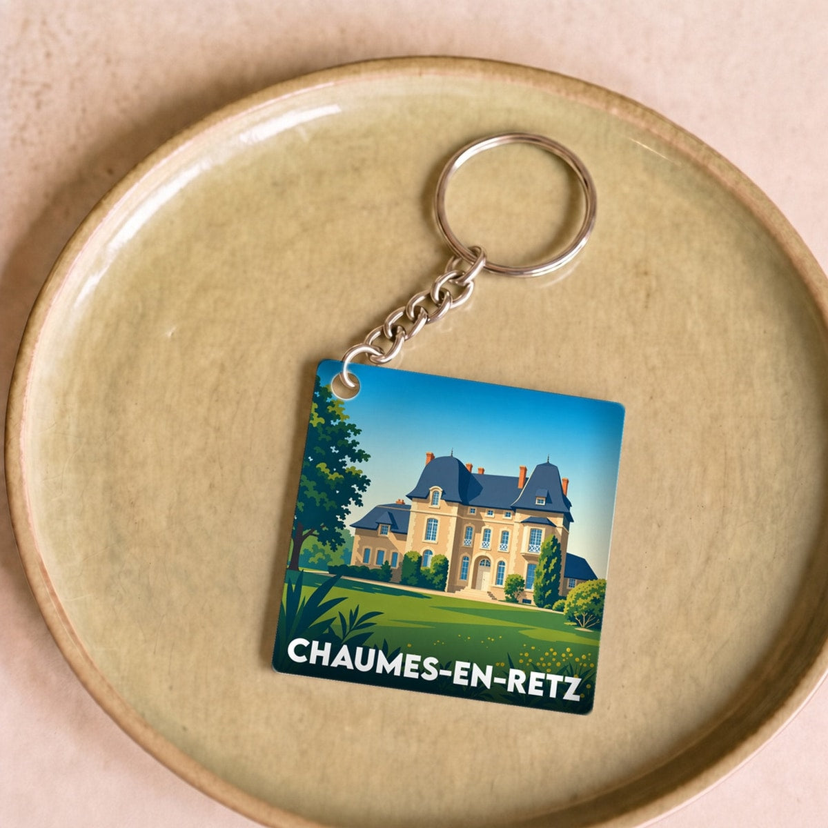 Porte-clés souvenir de la ville de Chaumes-en-Retz avec une illustration stylisée.