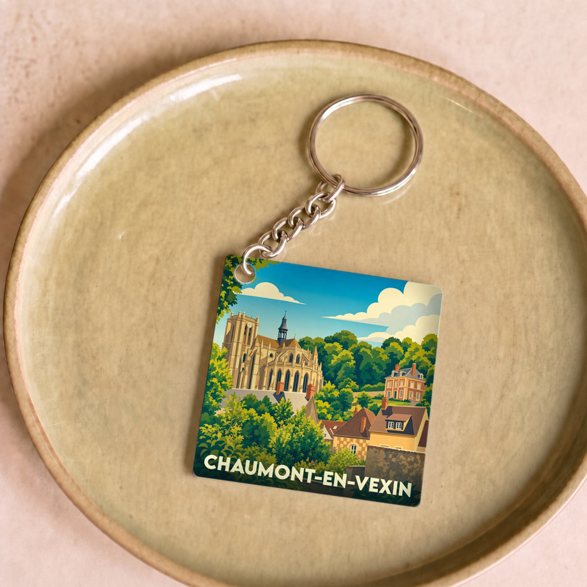 Porte-clés souvenir de la ville de Chaumont-en-Vexin avec une illustration stylisée.