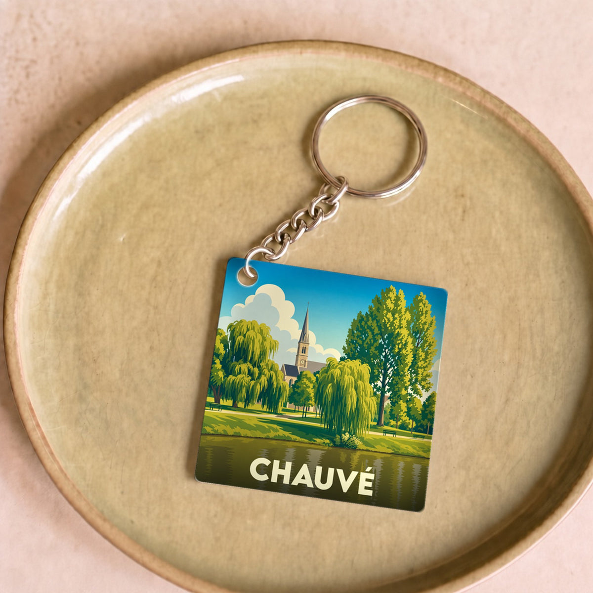 Porte-clés souvenir de la ville de Chauvé avec une illustration stylisée.