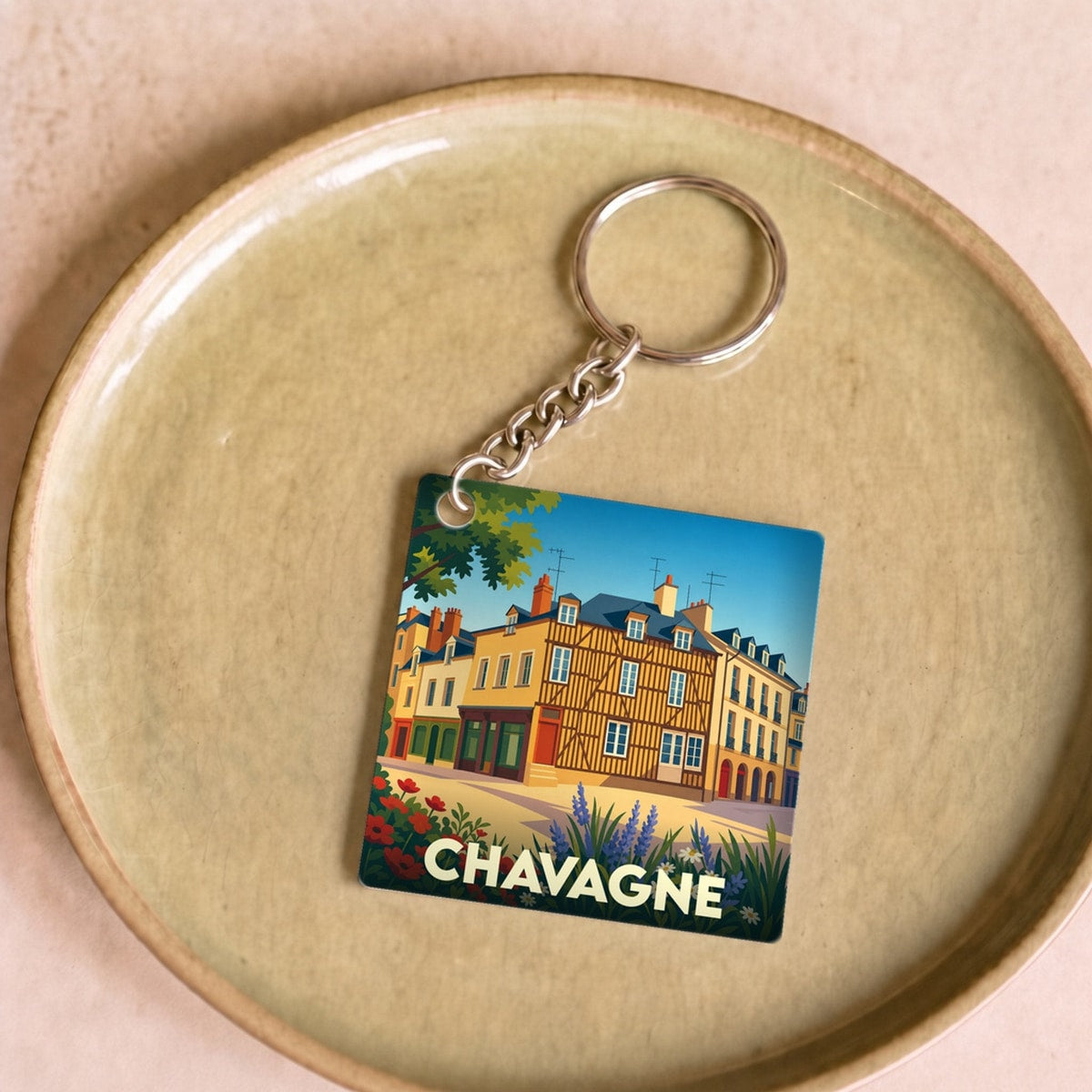 Porte-clés souvenir de la ville de Chavagne avec une illustration stylisée.
