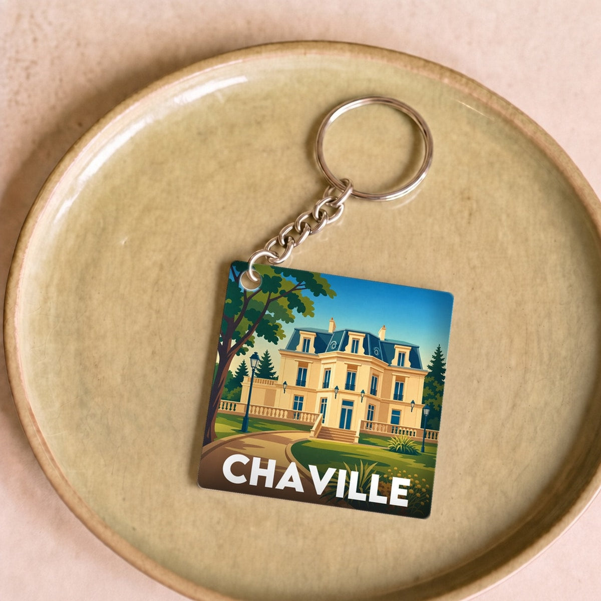Porte-clés souvenir de la ville de Chaville avec une illustration stylisée.