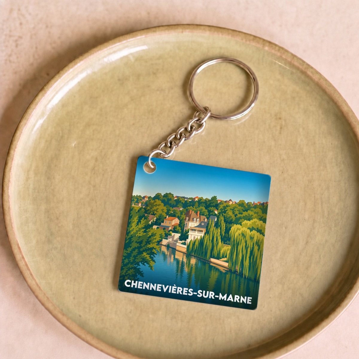 Porte-clés souvenir de la ville de Chennevières-sur-Marne avec une illustration stylisée.