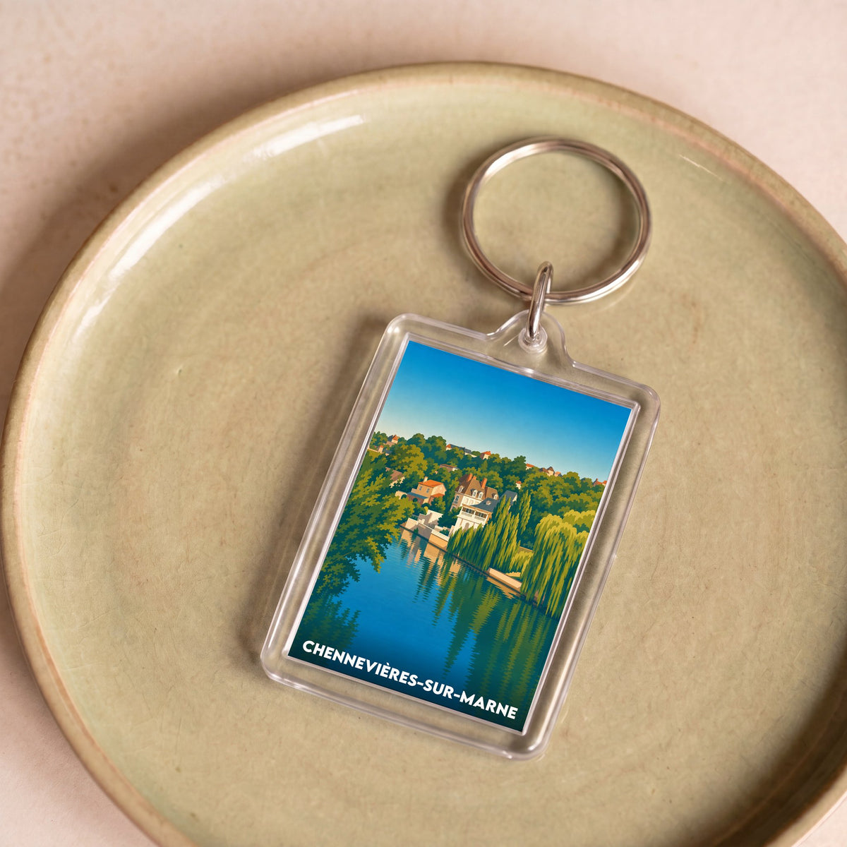 Porte-clés souvenir de la ville de Chennevières-sur-Marne avec une illustration stylisée.