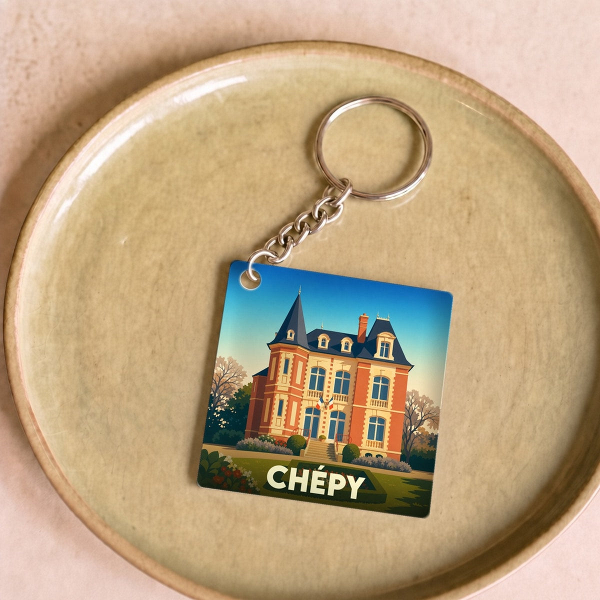 Porte-clés souvenir de la ville de Chépy avec une illustration stylisée d'un château.