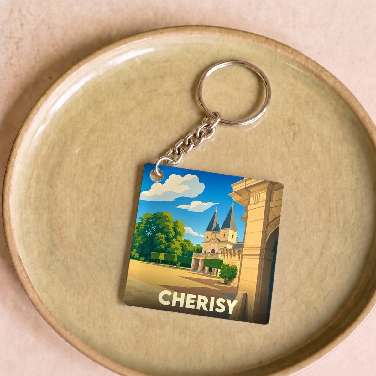 Porte-clés souvenir de la ville de Cherisy avec une illustration stylisée.