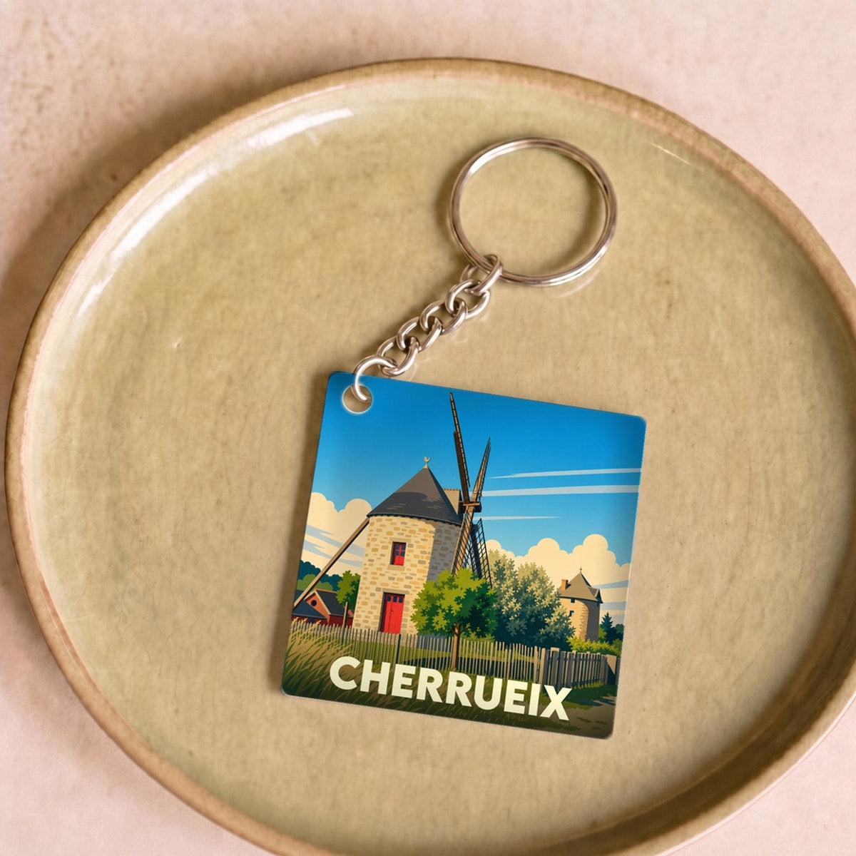Porte-clés souvenir de la ville de Cherrueix avec une illustration stylisée de ses moulins.