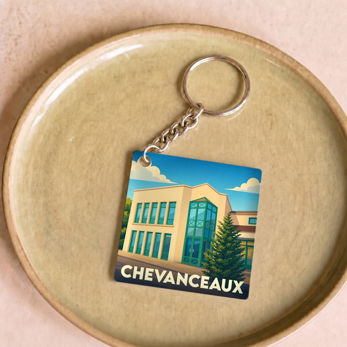 Porte-clés souvenir de la ville de Chevanceaux avec une illustration stylisée.