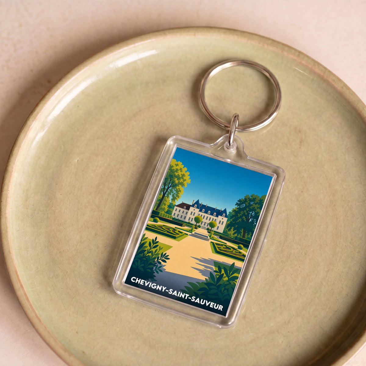 Porte-clés souvenir de la ville de Chevigny-Saint-Sauveur avec une illustration stylisée de son château.