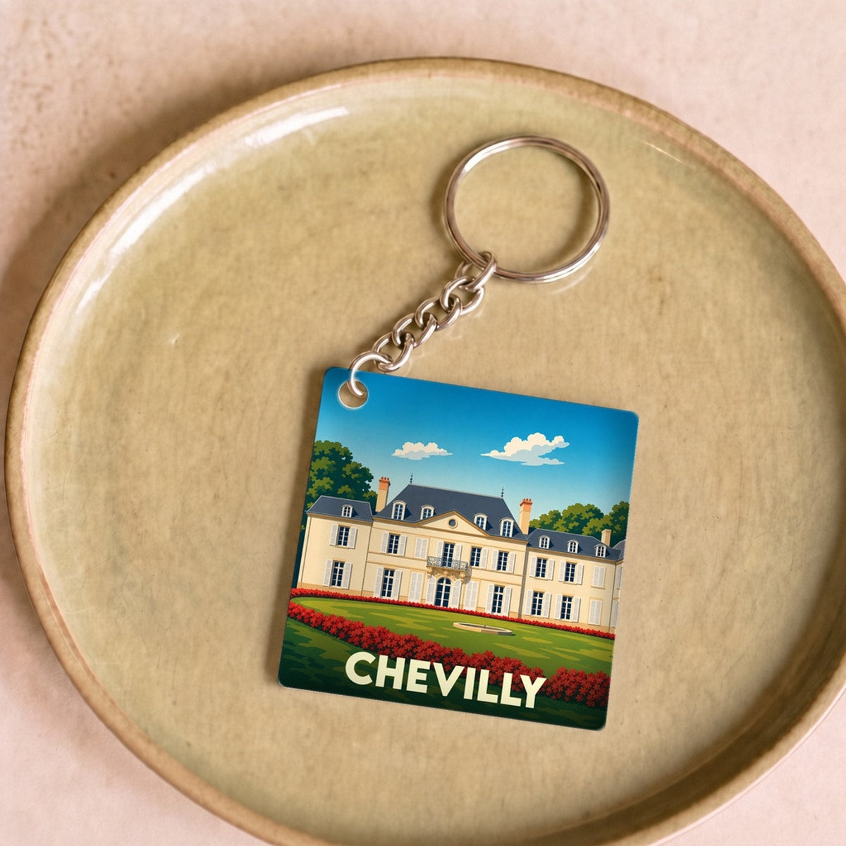 Porte-clés souvenir de la ville de Chevilly avec une illustration stylisée de son château.