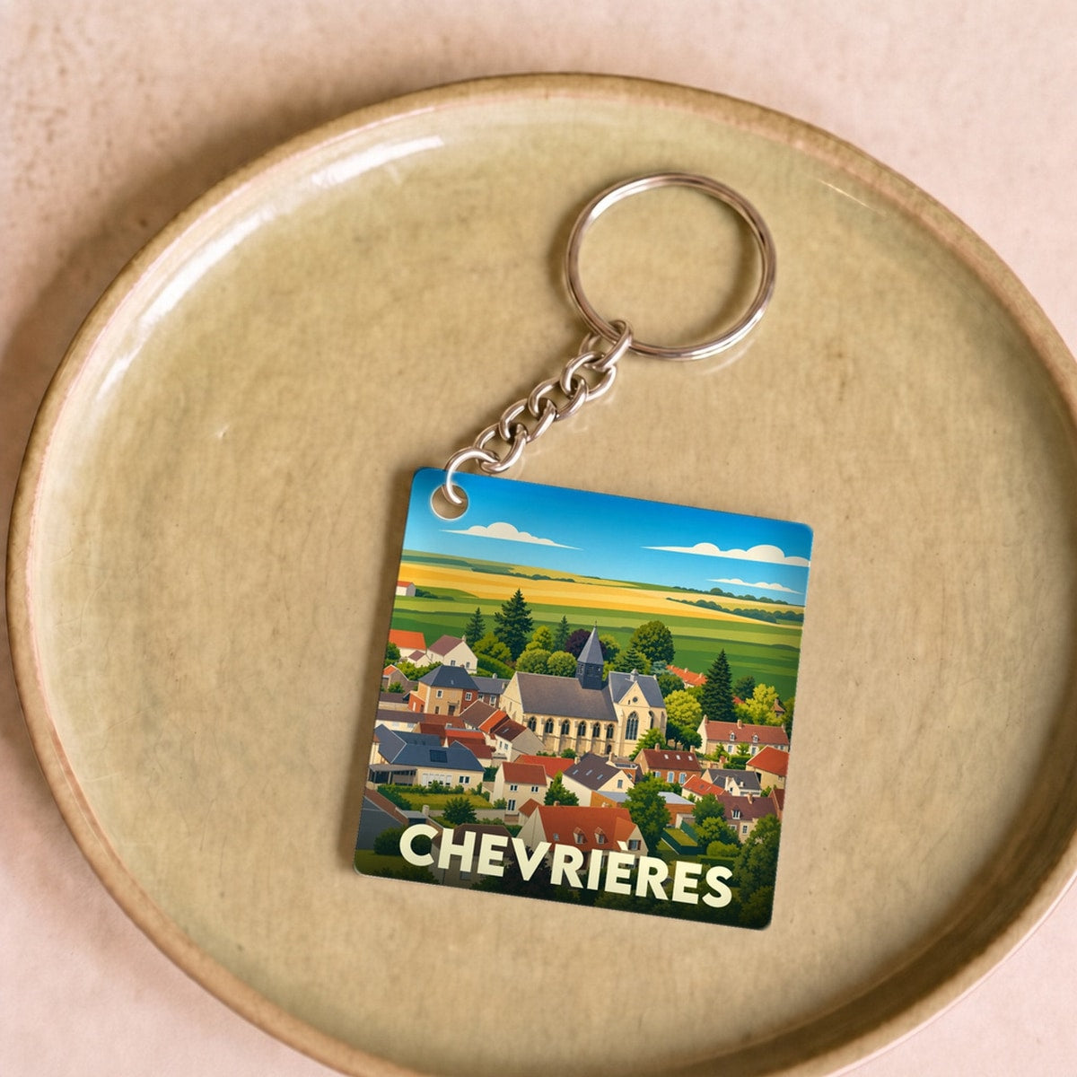 Porte-clés souvenir de la ville de Chevrières avec une illustration stylisée.