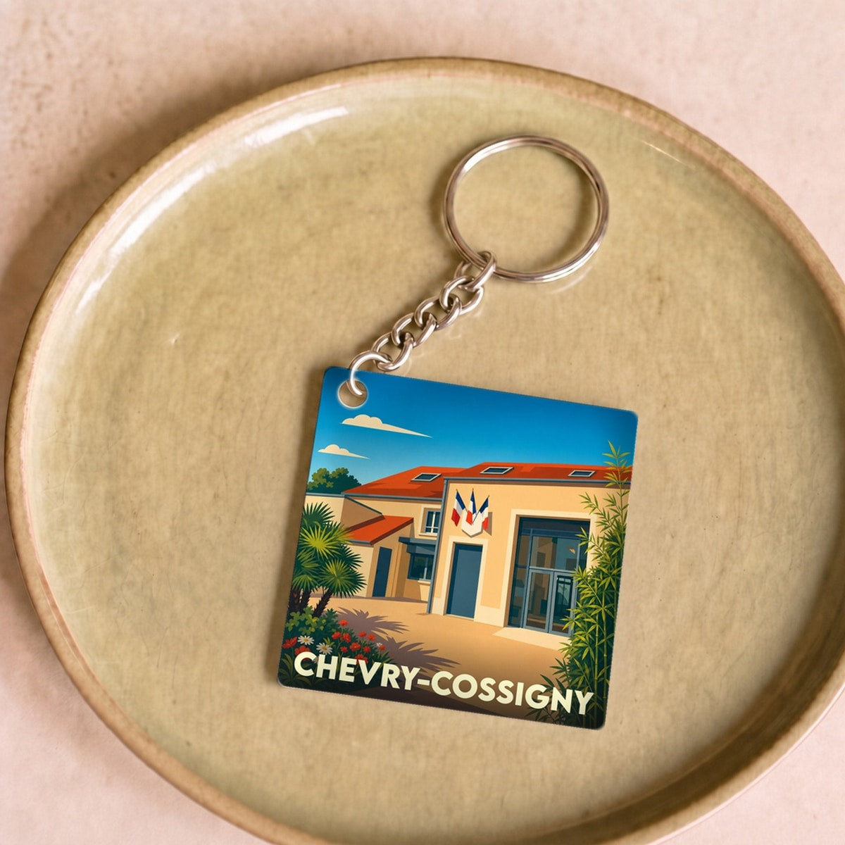 Porte-clés souvenir de la ville de Chevry-Cossigny avec une illustration stylisée.